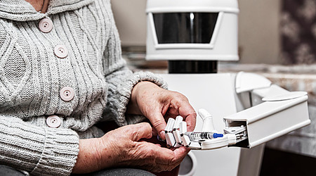 autonomous caregiver robot is holding a insulin syringe